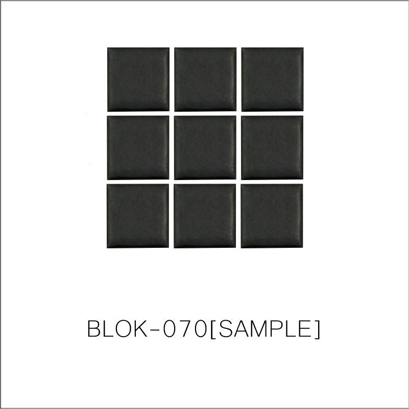 A sheet of square porcelain tiles in black color, arranged in a grid pattern.