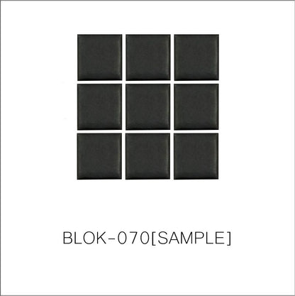 A sheet of square porcelain tiles in black color, arranged in a grid pattern.