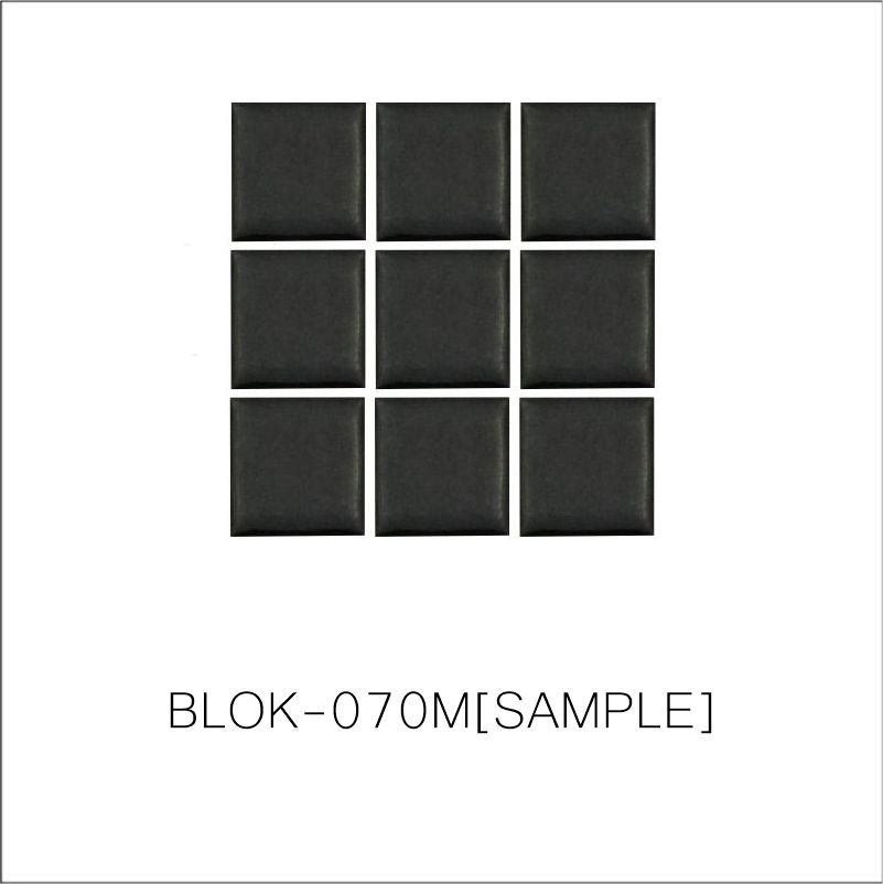A sheet of square porcelain tiles in black color, arranged in a grid pattern.