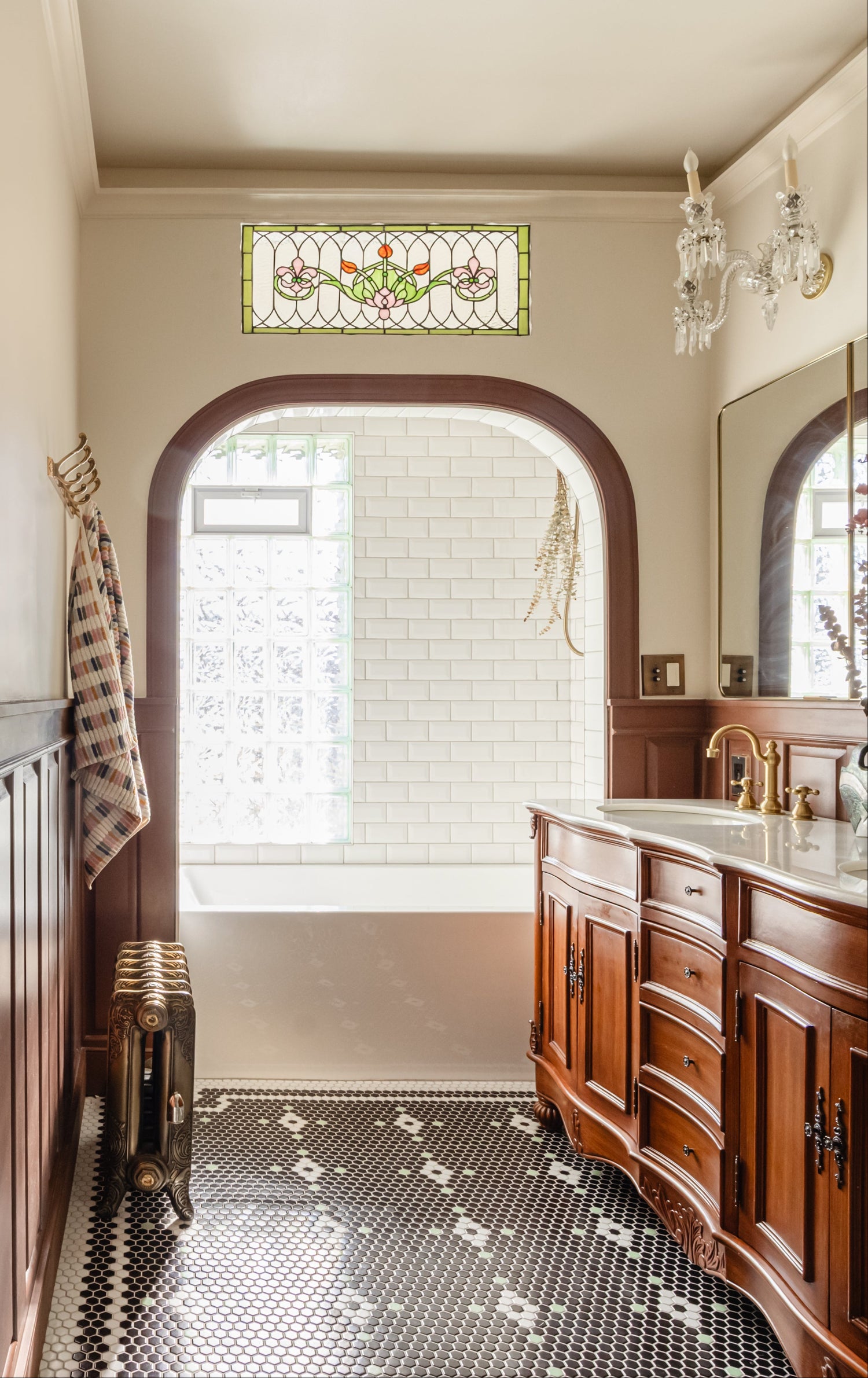Vintage bathroom featuring a patterned floor styled with Victorian tiles.