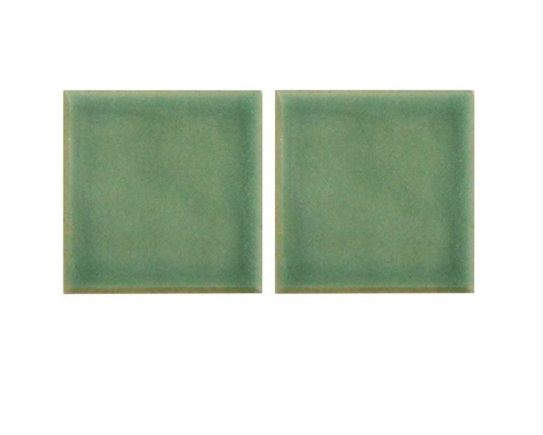 Two green rectangular tiles on a white background