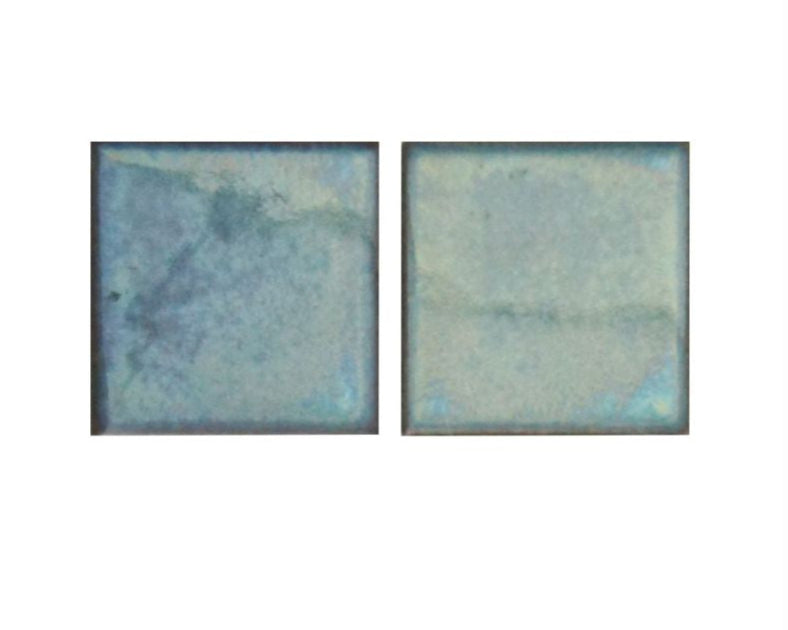 Two blue ceramic tiles with a textured surface on a white background