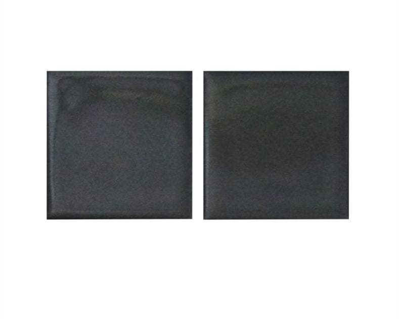 Two black square tiles on a white background