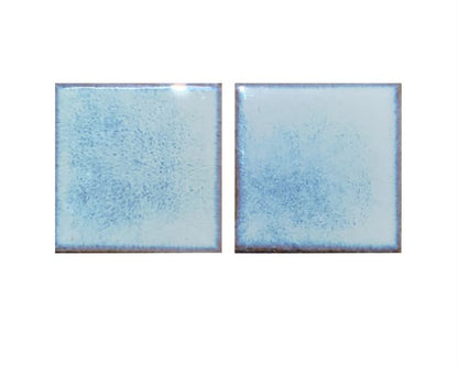 Two blue ceramic tiles on a white background