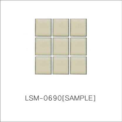 A sheet of square porcelain tiles with a yellow finish, arranged in a mosaic pattern.