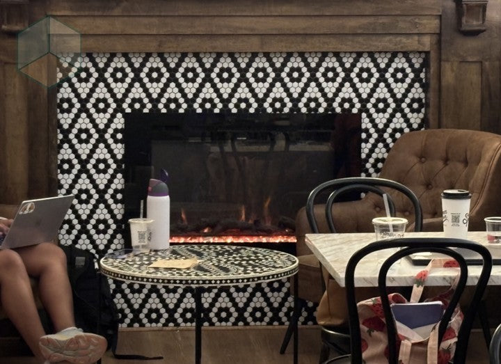Cafe fireplace with Diamond Rosette tile as the border.