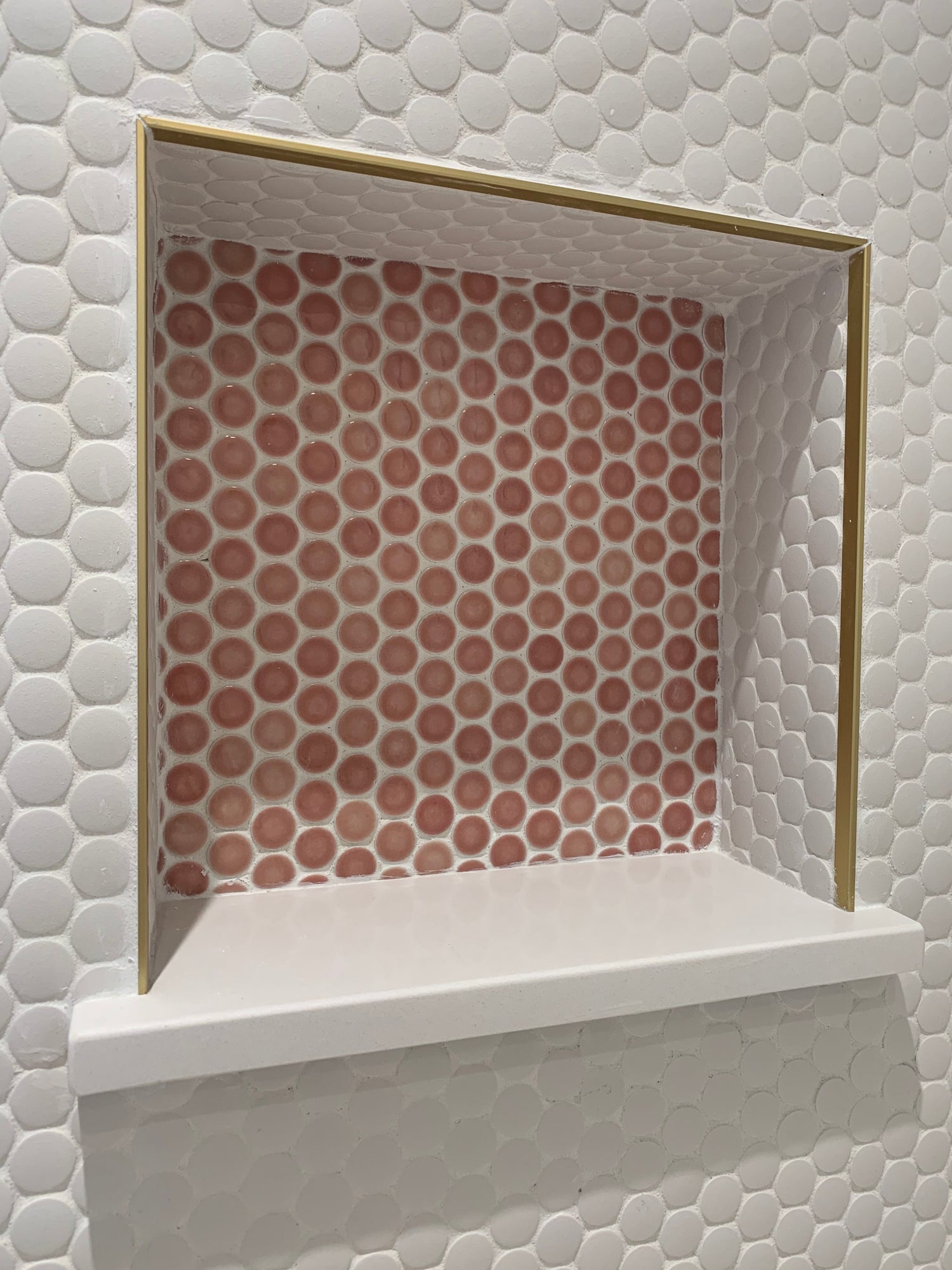 white and pink penny round tiles by Mosaic Tiles used on a wall