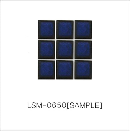 A sheet of square porcelain tiles with a glazed blue finish, arranged in a mosaic pattern.